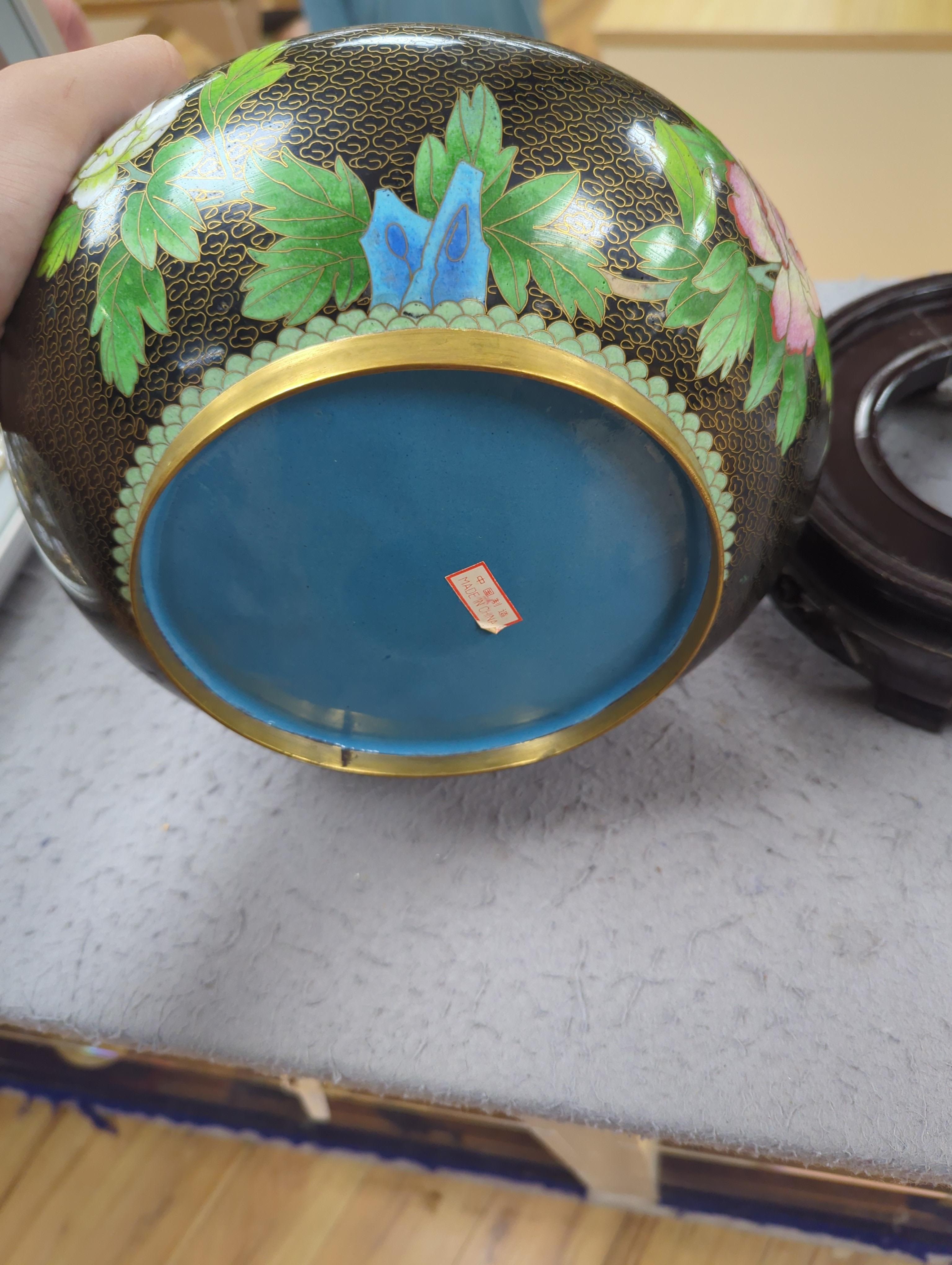 A Chinese cloisonné enamel three footed vase and cover together with a censer and cover, each raised on hardwood stands, the largest 26cm in diameter